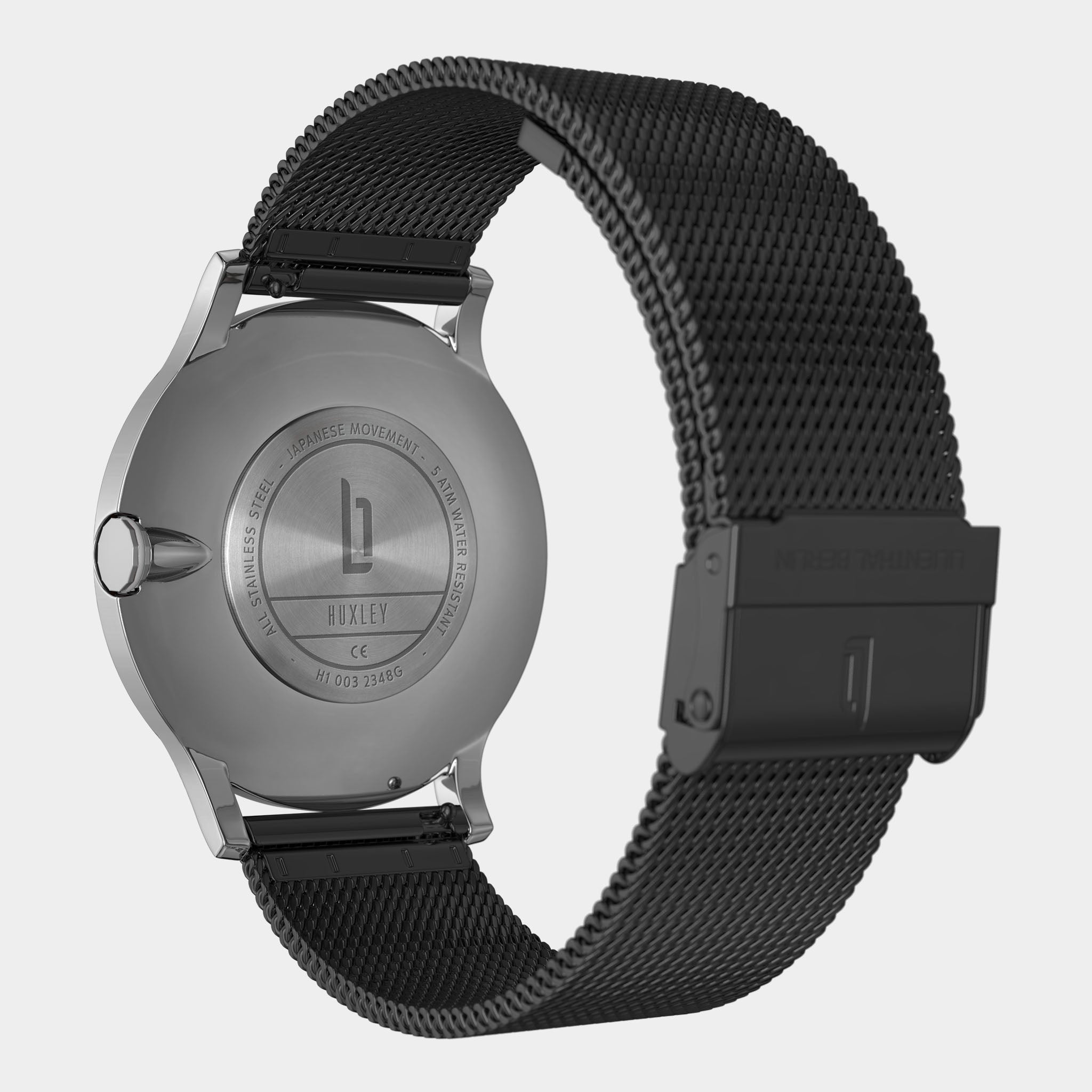 Back view of stainless steel watch with mesh strap and engraved case details