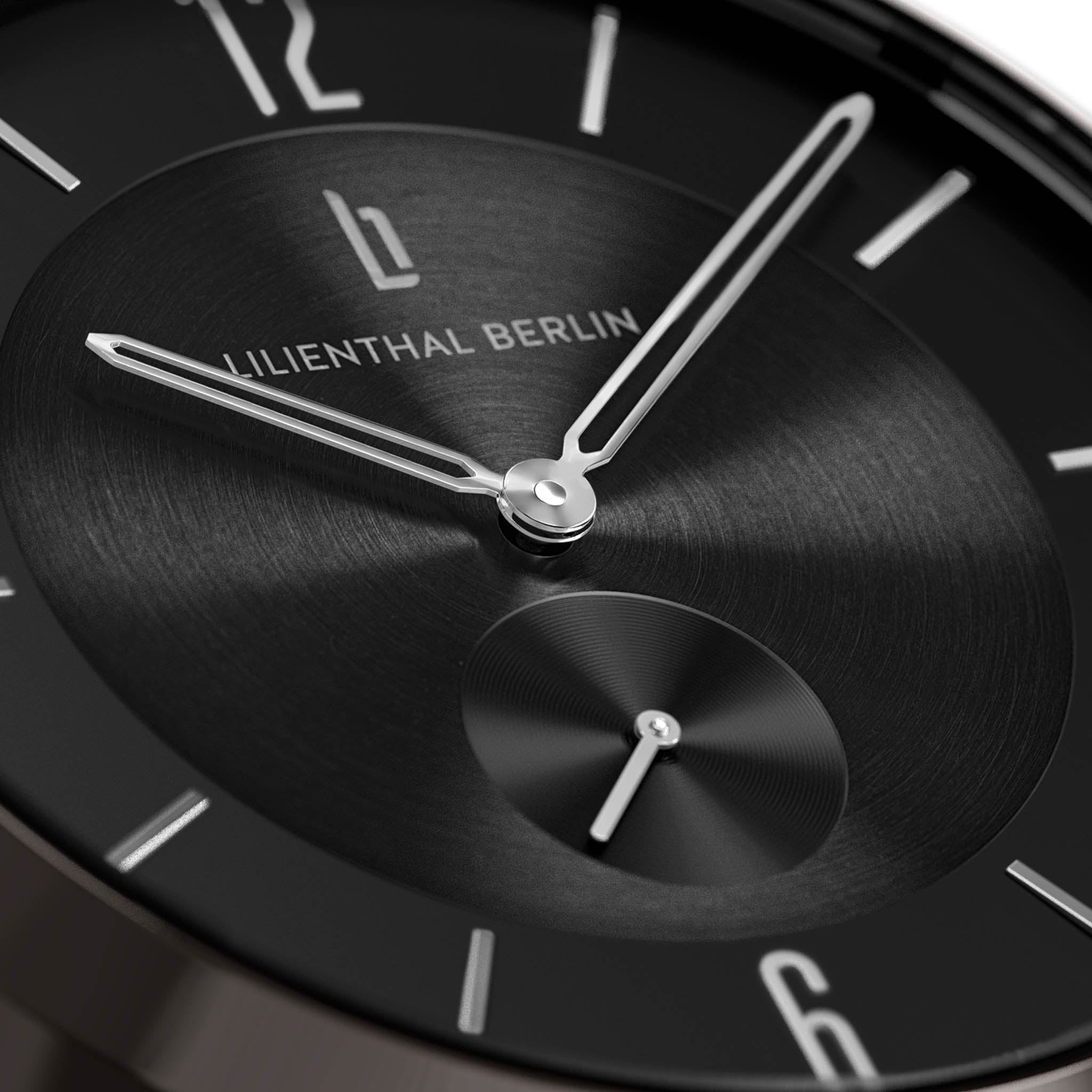 Close-up of a minimalist black watch face with silver hour and minute hands