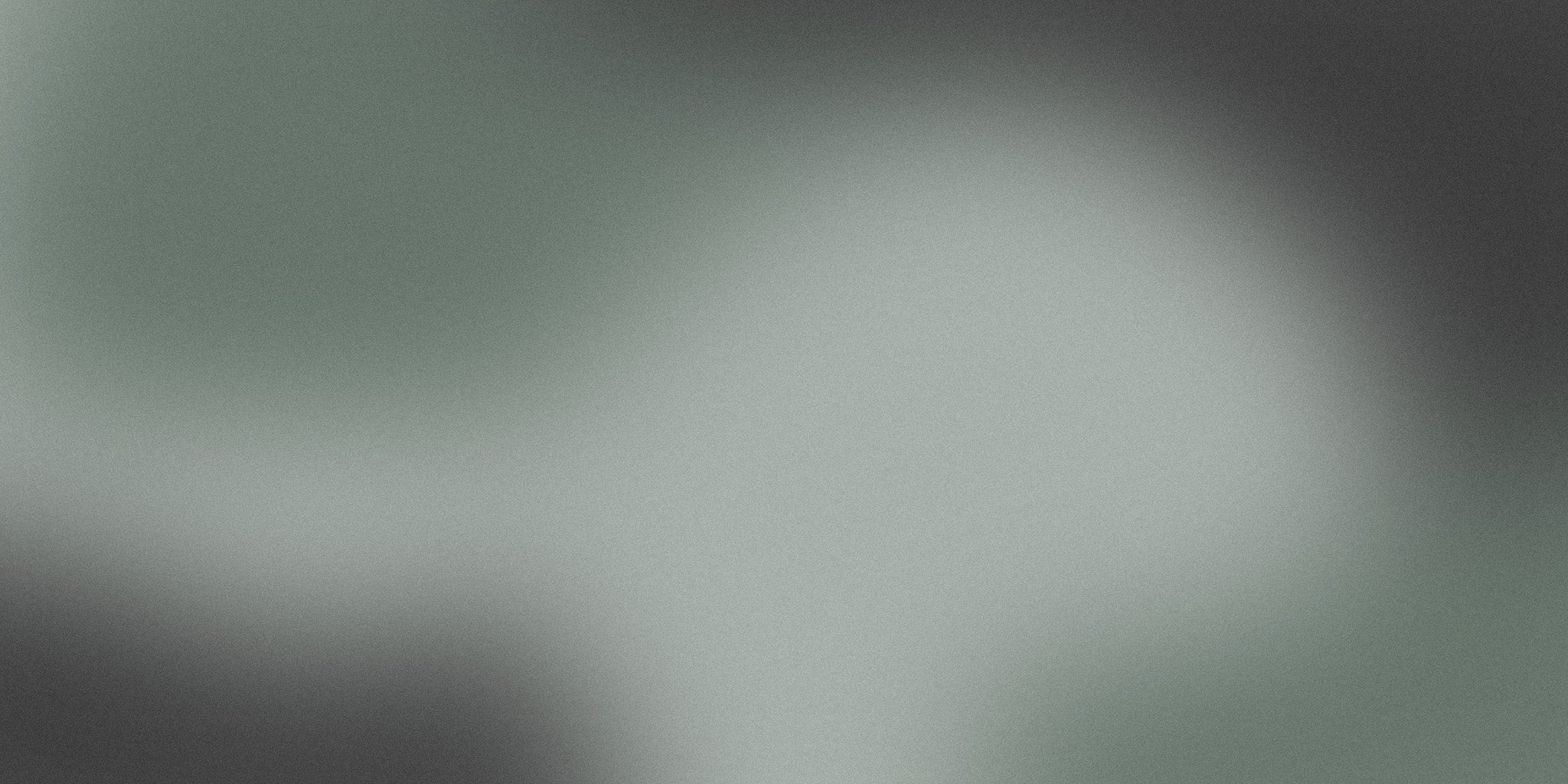 Minimalist abstract background with smooth grey and green gradient, soft texture.