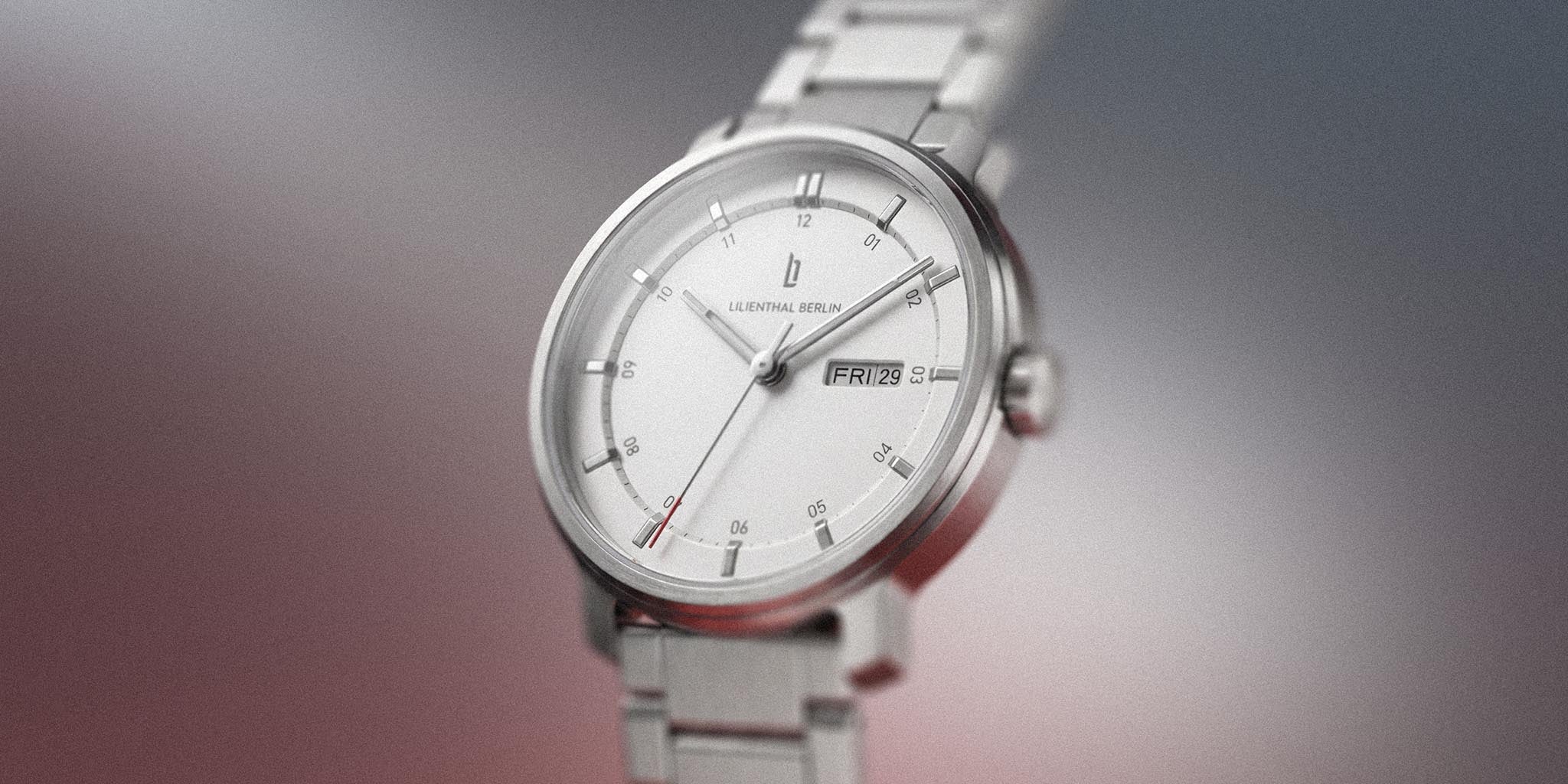 Silver stainless steel wristwatch with white dial and day-date display