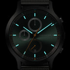 Sleek black chronograph watch with luminous hands, subdials, and minimalist markers on dark face