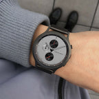 Minimalist chronograph watch with grey dial and black subdials on wrist, modern outfit