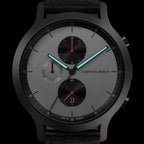 Modern men's chronograph watch with black case, silver dial, subdials, and blue hands