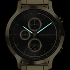 Black and gold chronograph watch with luminous hands and minimalist subdials