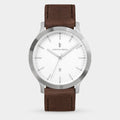 Minimalist silver wristwatch with white dial and brown leather strap on light background