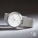 Minimalist silver mesh watch with white dial, date display, and German Design Award 2021 badge