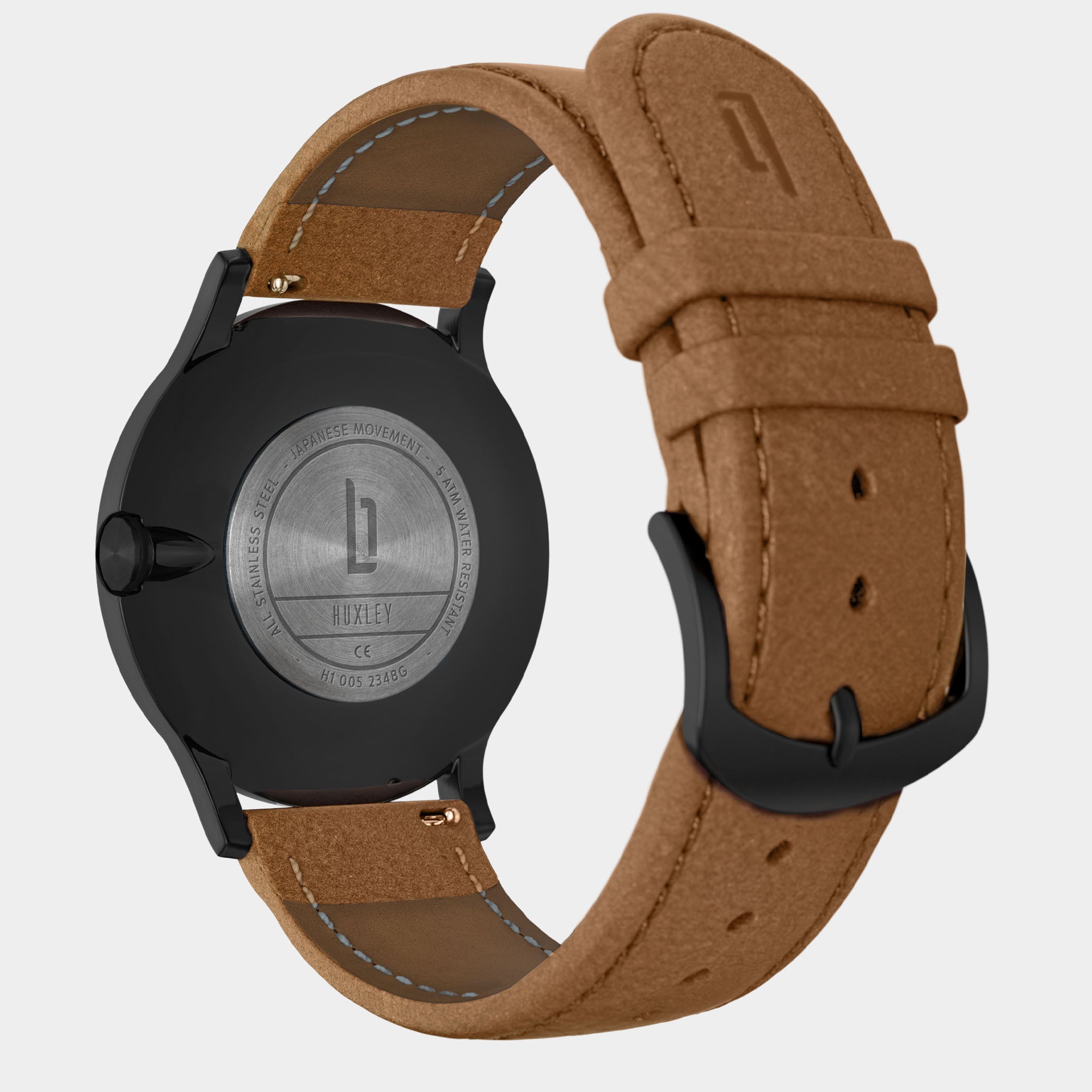 Black stainless steel watch case with brown leather strap and engraved back, minimalist design