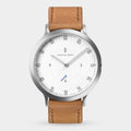 Minimalist watch with white dial, tan leather strap, and silver case on white background.