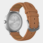 Stainless steel watch case with brown leather strap, engraved back and silver buckle