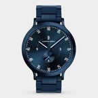 Sleek dark blue wristwatch with metal strap, minimalist dial, and small seconds subdial.