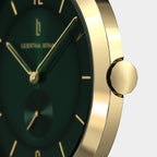 Close-up of elegant gold watch case with green dial and gold hour markers