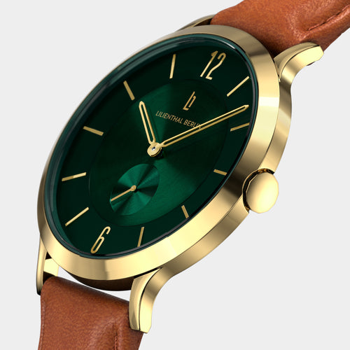 Gold watch with green dial, brown leather strap, minimalist design, close-up view